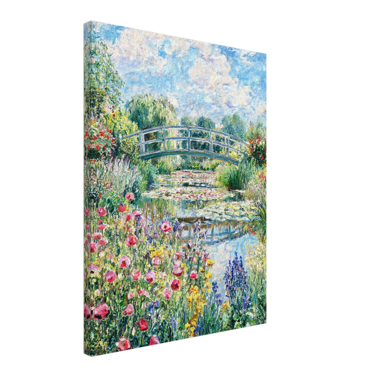 A vertical canvas wall art print depicting a vibrant garden scene with a white arched bridge over a pond, surrounded by pink flowers, green foliage, and a blue sky with clouds, shown at a three-quarter angle on a white background.