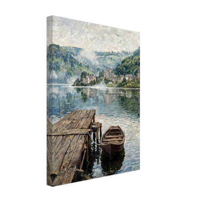 A gallery-wrapped canvas print featuring an impressionist landscape painting of a quiet lakeside village with a wooden dock and rowboat, shown at an angle against a plain white background.