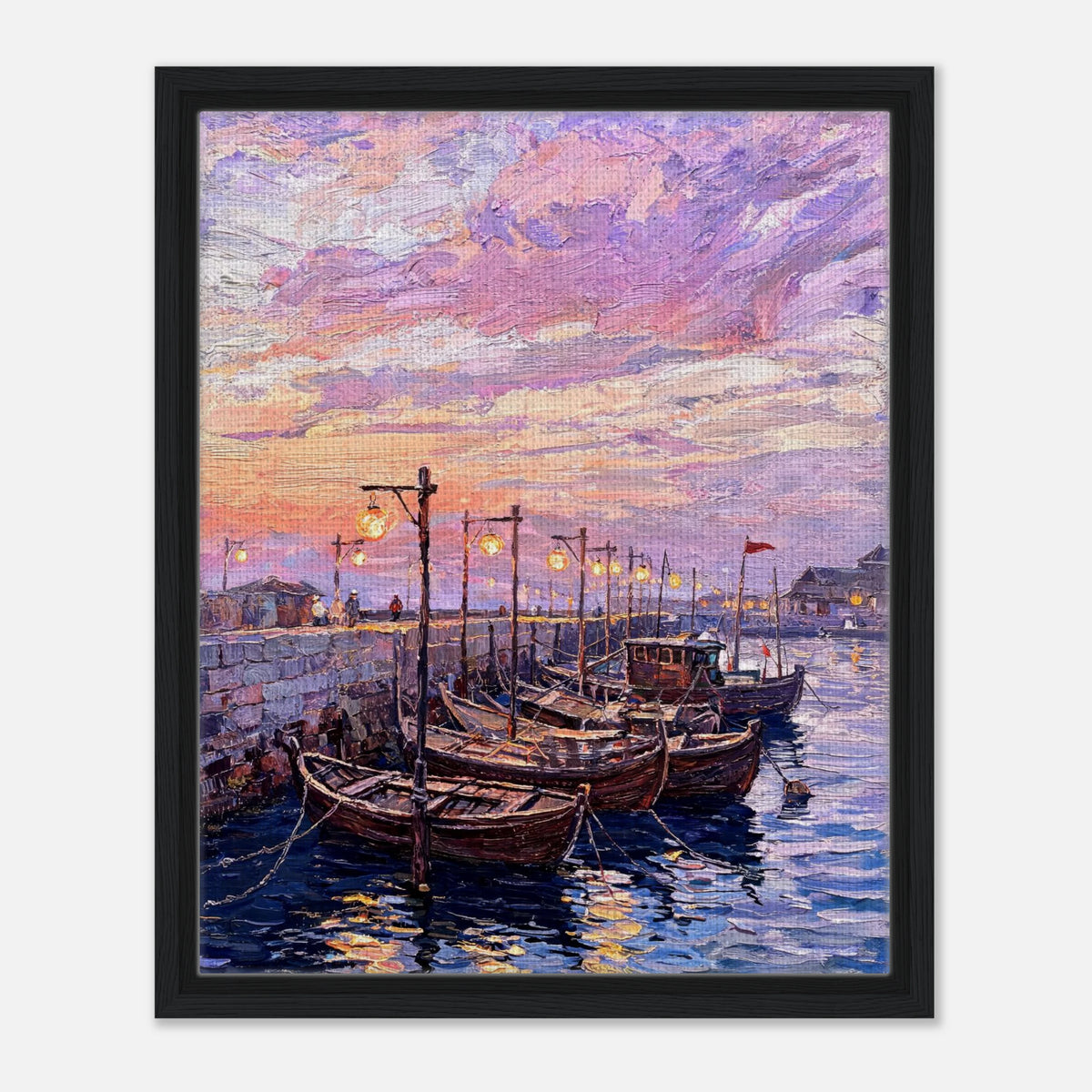 A framed canvas art print depicting a colorful sunset harbor scene with wooden boats moored in calm water under a pink, purple, and orange sky.