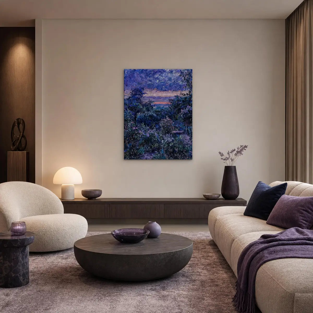 A modern living room featuring a square canvas art print of a blue and purple forest landscape hanging on a beige wall above a dark wood console table.