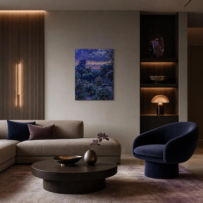 A framed abstract landscape painting in deep blues and purples hangs on a beige wall in a modern living room with a gray sofa, dark blue armchair, and round coffee table.
