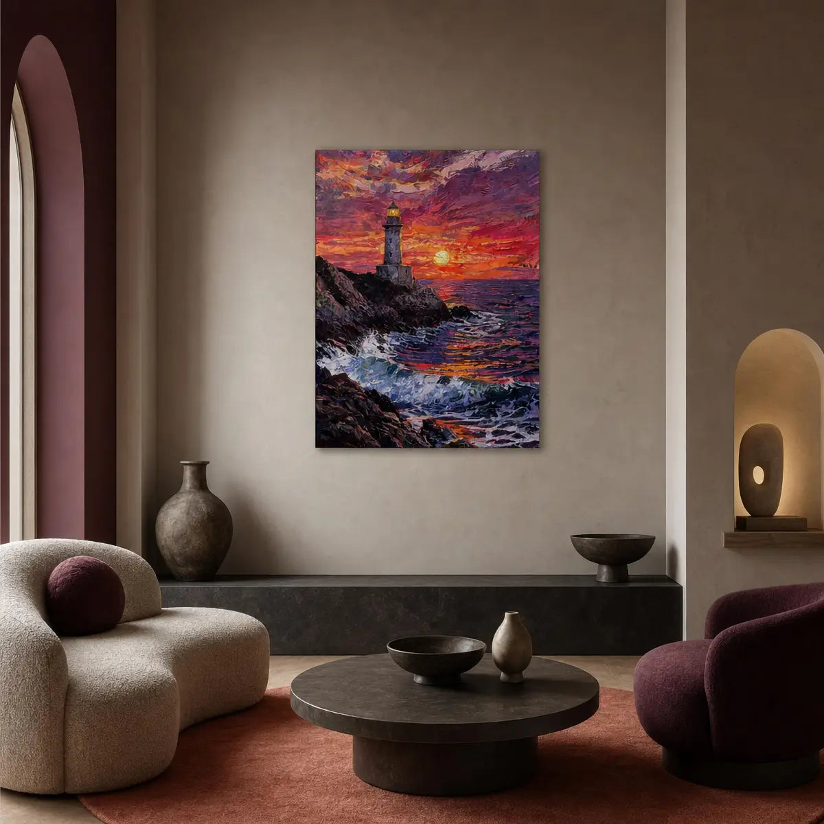 A vertical canvas print of a colorful sunset lighthouse painting hanging on a beige wall in a modern, stylishly decorated living room with curved armchairs and a round coffee table.