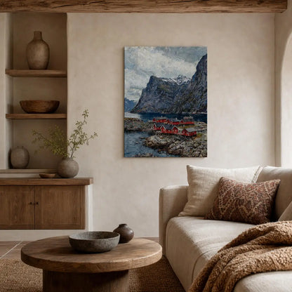 A vertical canvas print of a Norwegian fjord landscape with red houses and rocky mountains, displayed on a beige wall in a styled living room setting.