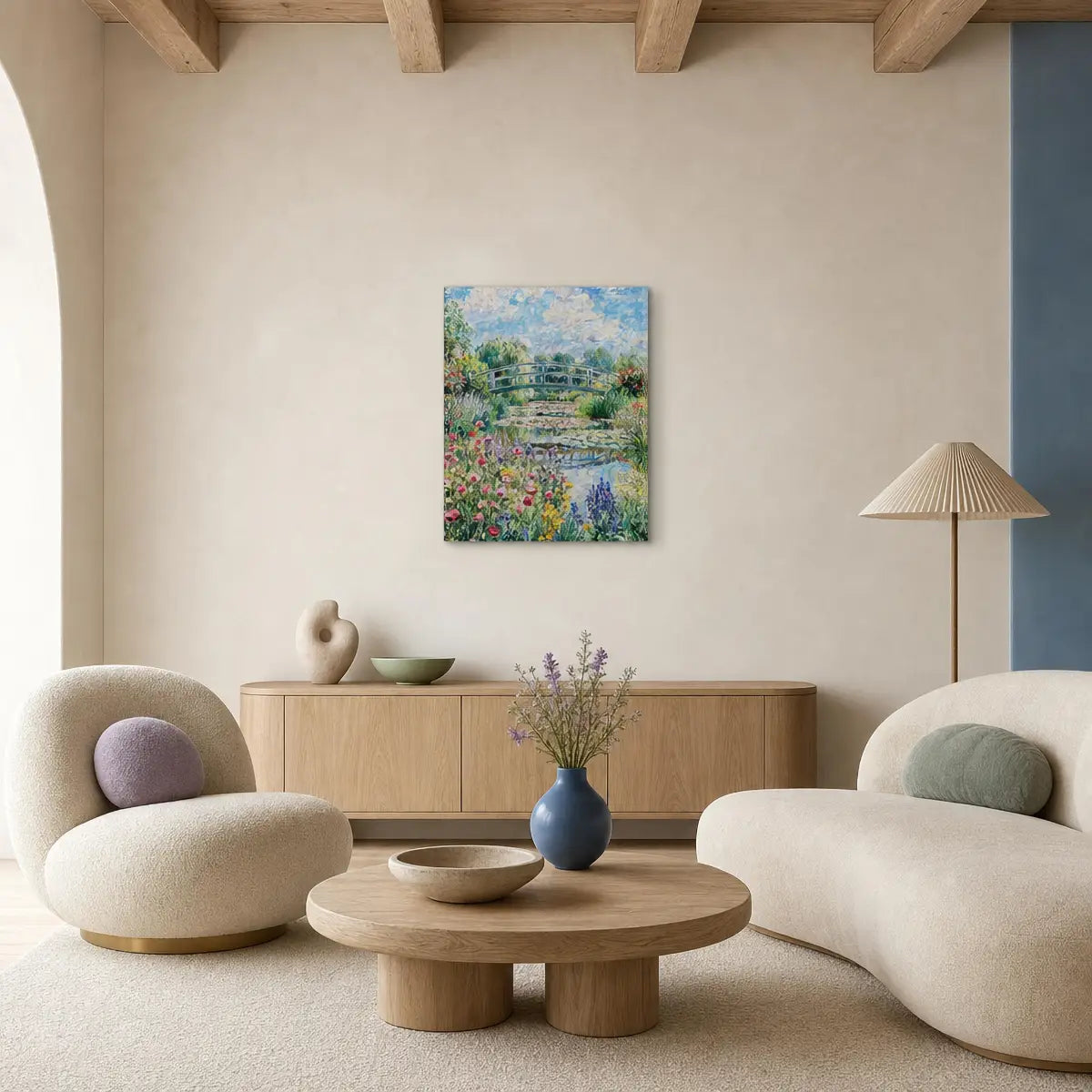A framed colorful floral landscape painting hangs on a beige wall in a modern, minimalist living room with cream-colored furniture, a wooden coffee table, and a pleated floor lamp.