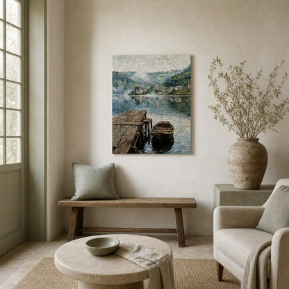 A framed landscape art print depicting a serene lake with a wooden dock and boat, displayed on a beige wall in a styled living room setting with a bench, armchair, and vase.