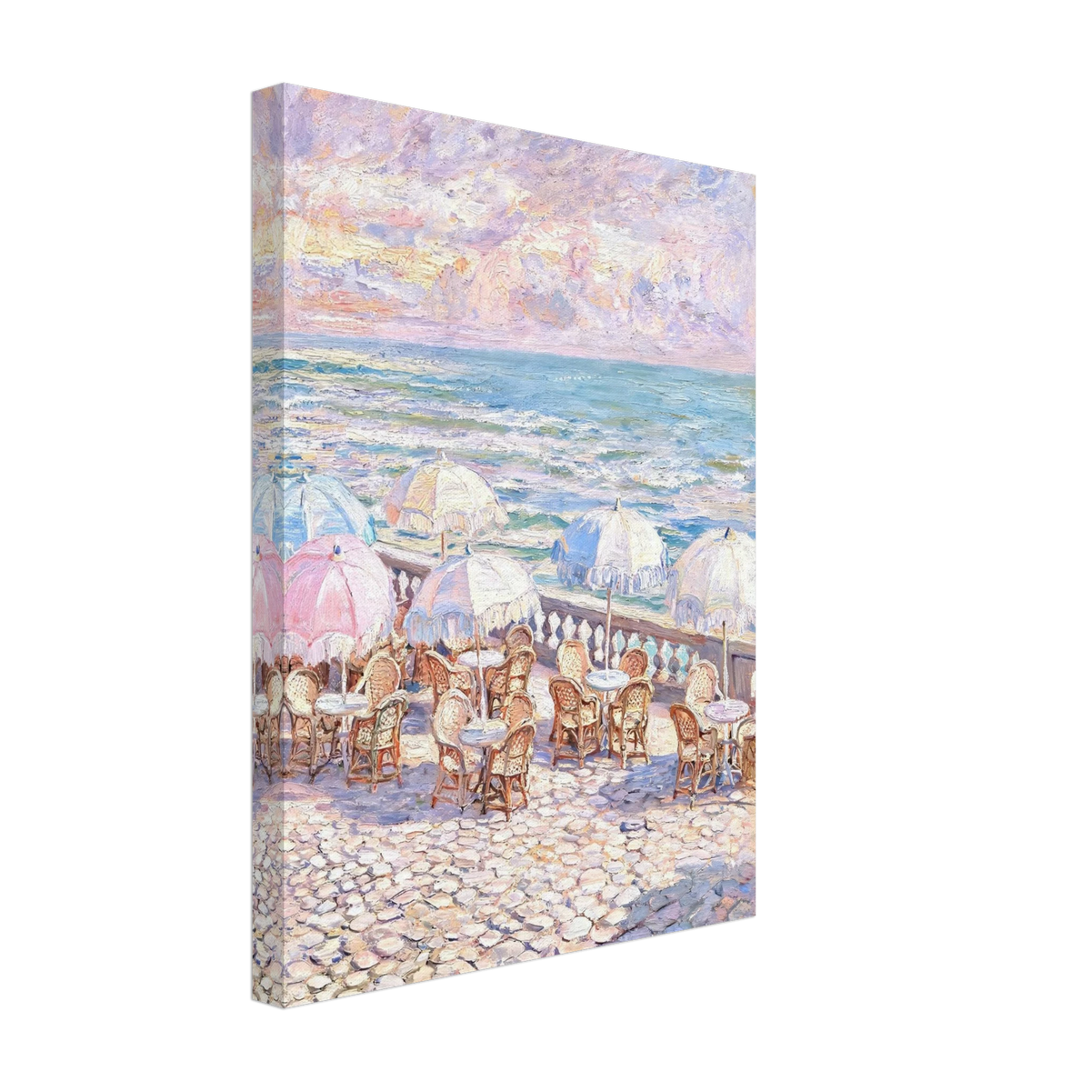 A vertical canvas wall art print depicting an impressionist seaside cafe scene with pastel umbrellas, tables, and a rocky beach under a cloudy sky, shown at an angle on a white background.
